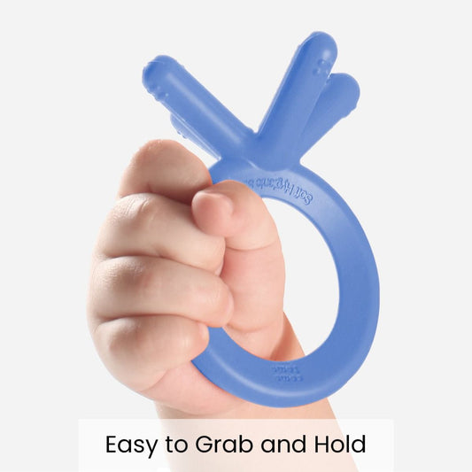 Como Tomo Blue Silicone Baby Teether in baby hand