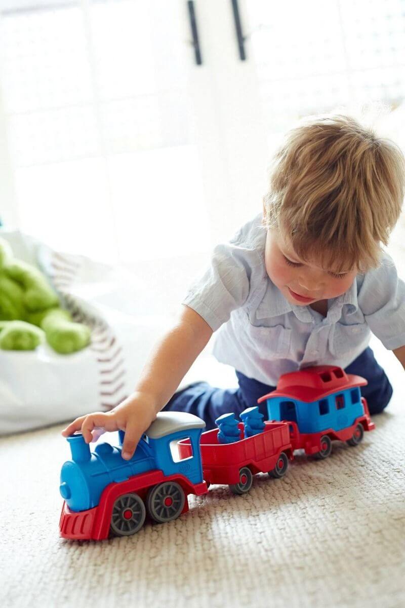 Toddler Playing with Non-Toxic Green Toys Train