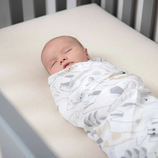 baby sleeping on organic crib mattress