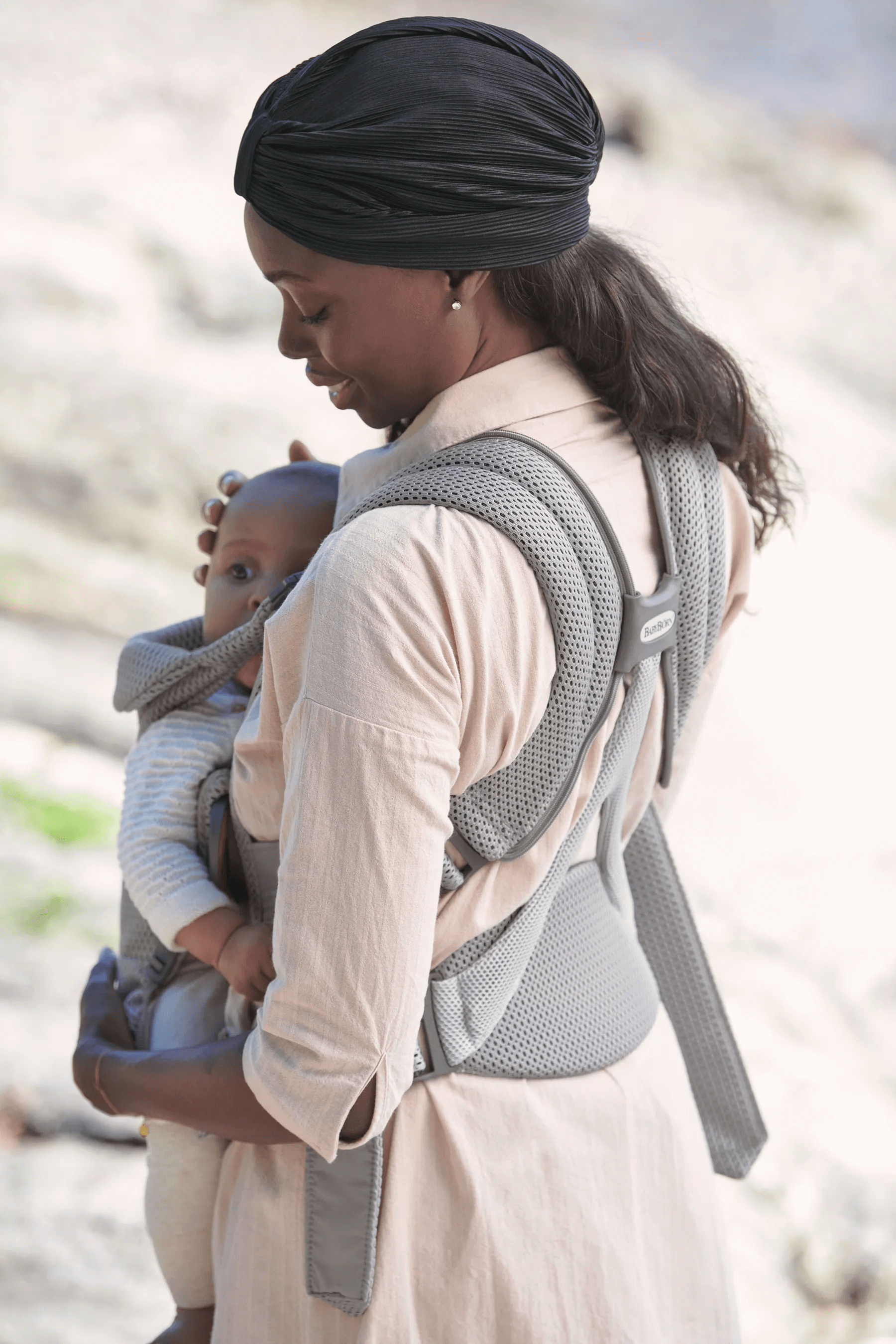 Mom holding baby in BabyBjorn Baby Carrier Free in Grat 3DMesh