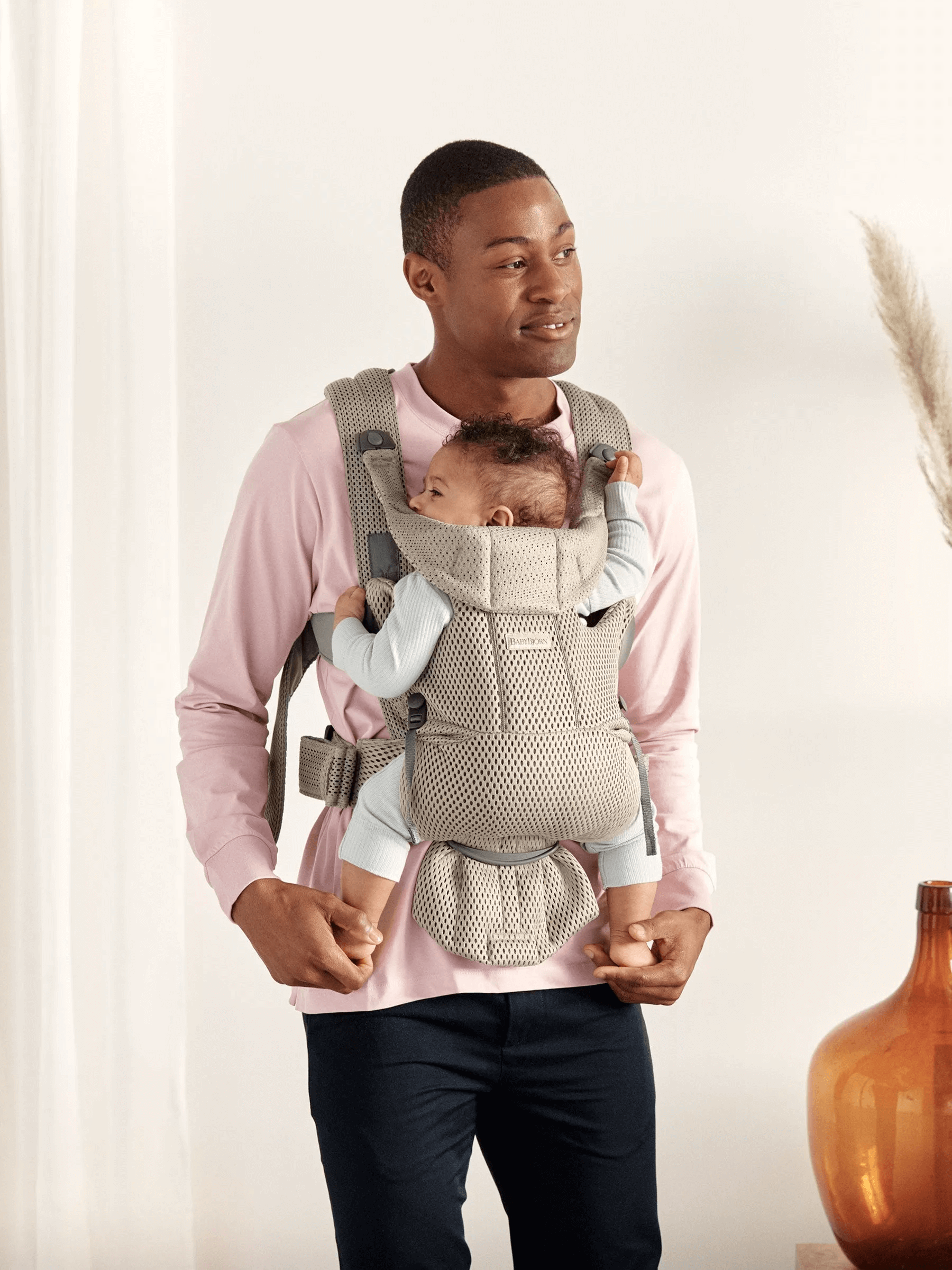 Dad holding baby in  BabyBjorn Baby Carrier Free in Beige 3DMesh