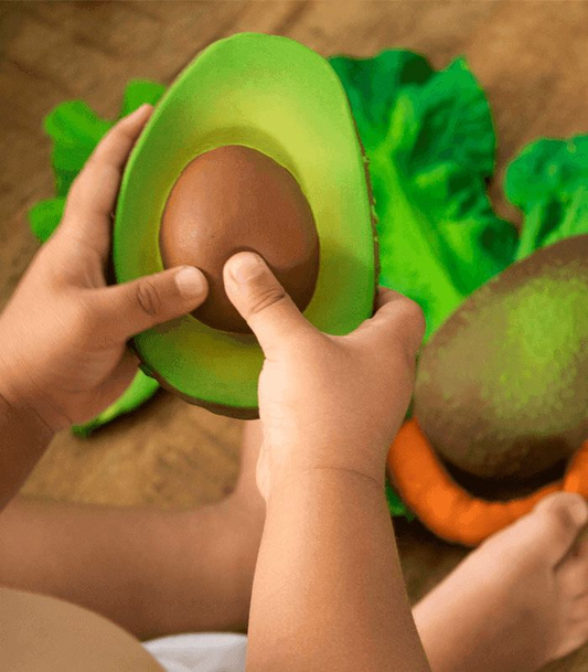 Avocado teether in baby hands