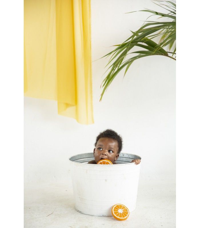 Olie and Carol Clementino the Orange Natural Rubber Teether with baby in bath
